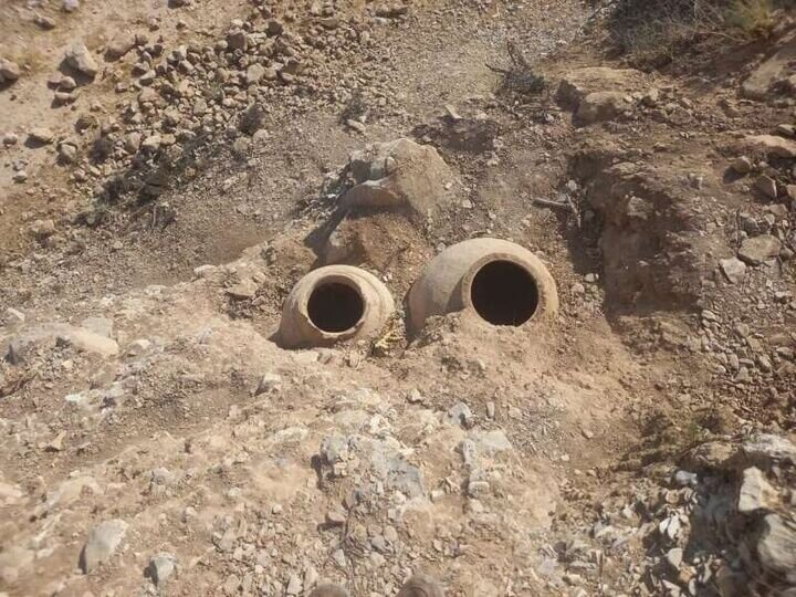 Ancient clay jars unearthed following road erosion in western Iran