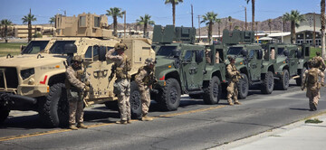 Marines stand near their vehicles as they prepare to depart for Los Angeles from an unknown location in this handout picture released on June 9, 2025. © US Northern Command (published on X) via Reuter
