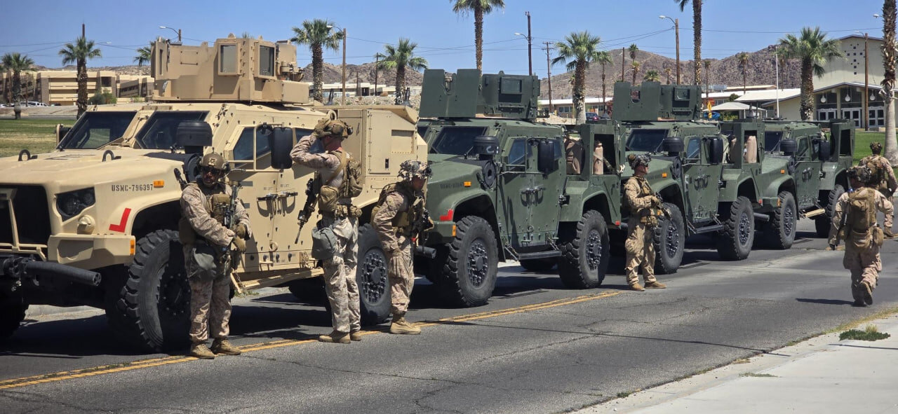Marines stand near their vehicles as they prepare to depart for Los Angeles from an unknown location in this handout picture released on June 9, 2025. © US Northern Command (published on X) via Reuter