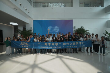 A delegation of international journalists poses for a group photo at Lenovo’s Tianjin facility on June 18, 2025