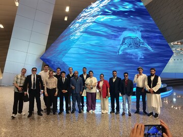 International journalists pose for a group photo at the Dalian International Conference Center on July 1, 2025