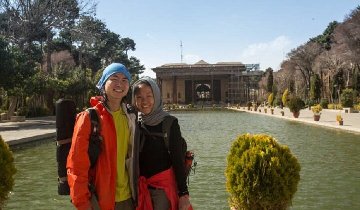 A file photo shows a Chinese couple posing for a photograph during their visit to the 17th-century Chehel Sotoun Palace in Isfahan, central Iran.