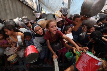 Photo caption: Palestinians gather to receive cooked meals from a food distribution center in the Nuseirat refugee camp in central Gaza on 18 August 2025. (AFP)
