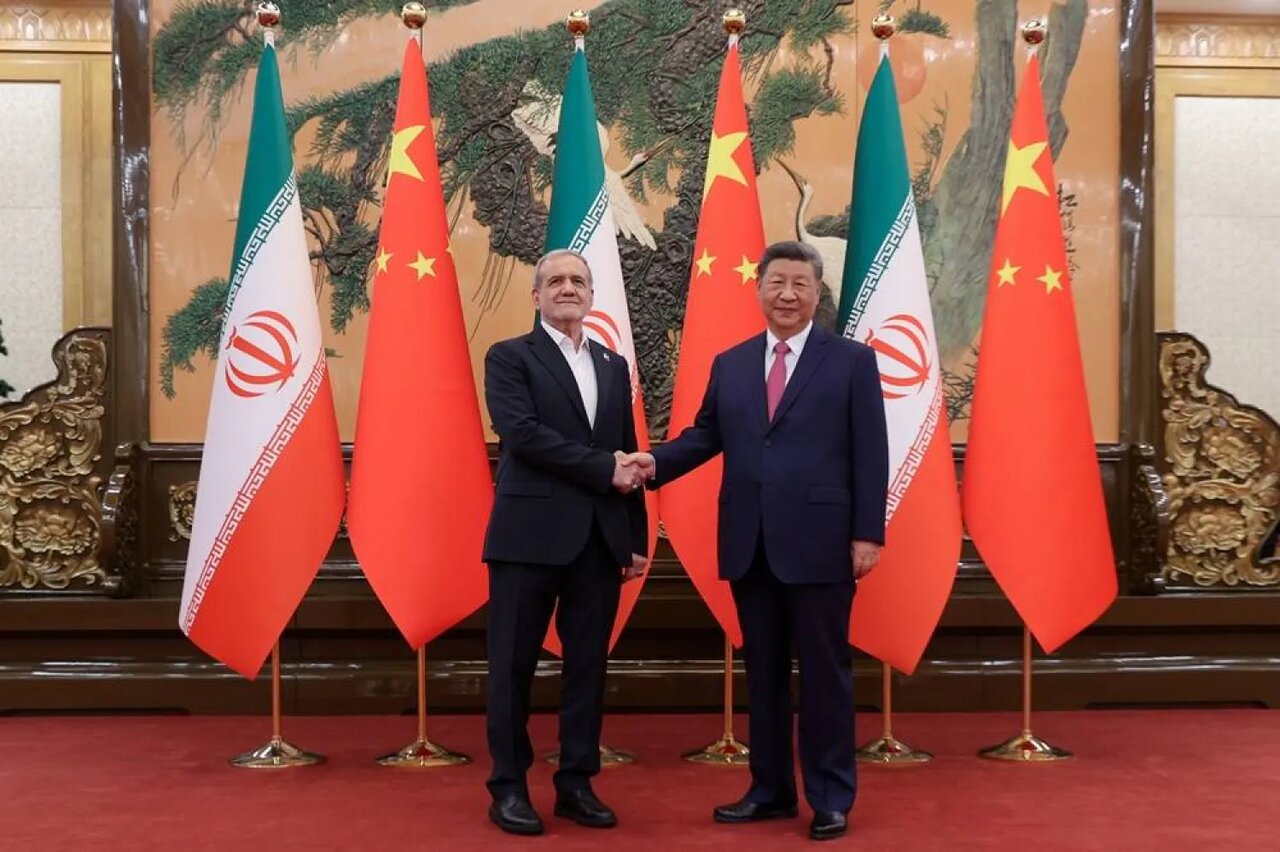 Iran’s President Masoud Pezeshkian shakes hands with Chinese President Xi Jinping in Beijing on September 2, 2025.