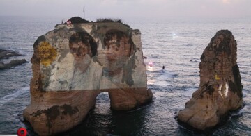 Portraits of two former Hezbollah leaders Hassan Nasrallah, right and Hashem Safieddine, left, are projected onto the landmark Raouche sea rock during an event commemorating their deaths in Israeli airstrikes a year ago, in Beirut, Lebanon, Thursday, Sept. 25, 2025. (AP Photo/Hussein Malla)