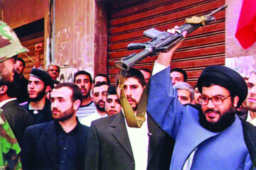 Nasrallah holding a rifle