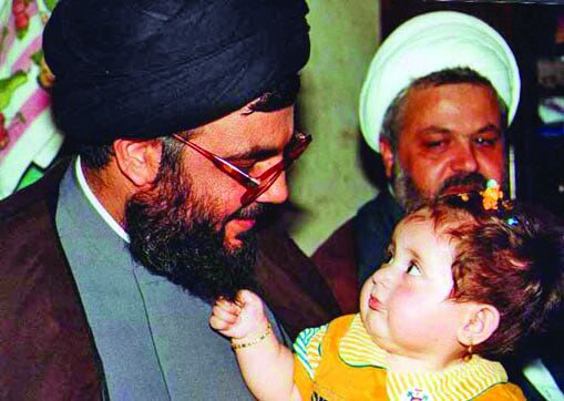 Nasrallah holding a baby