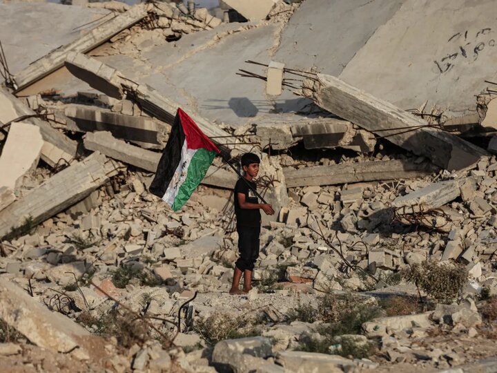 Gaza boy holding a flag