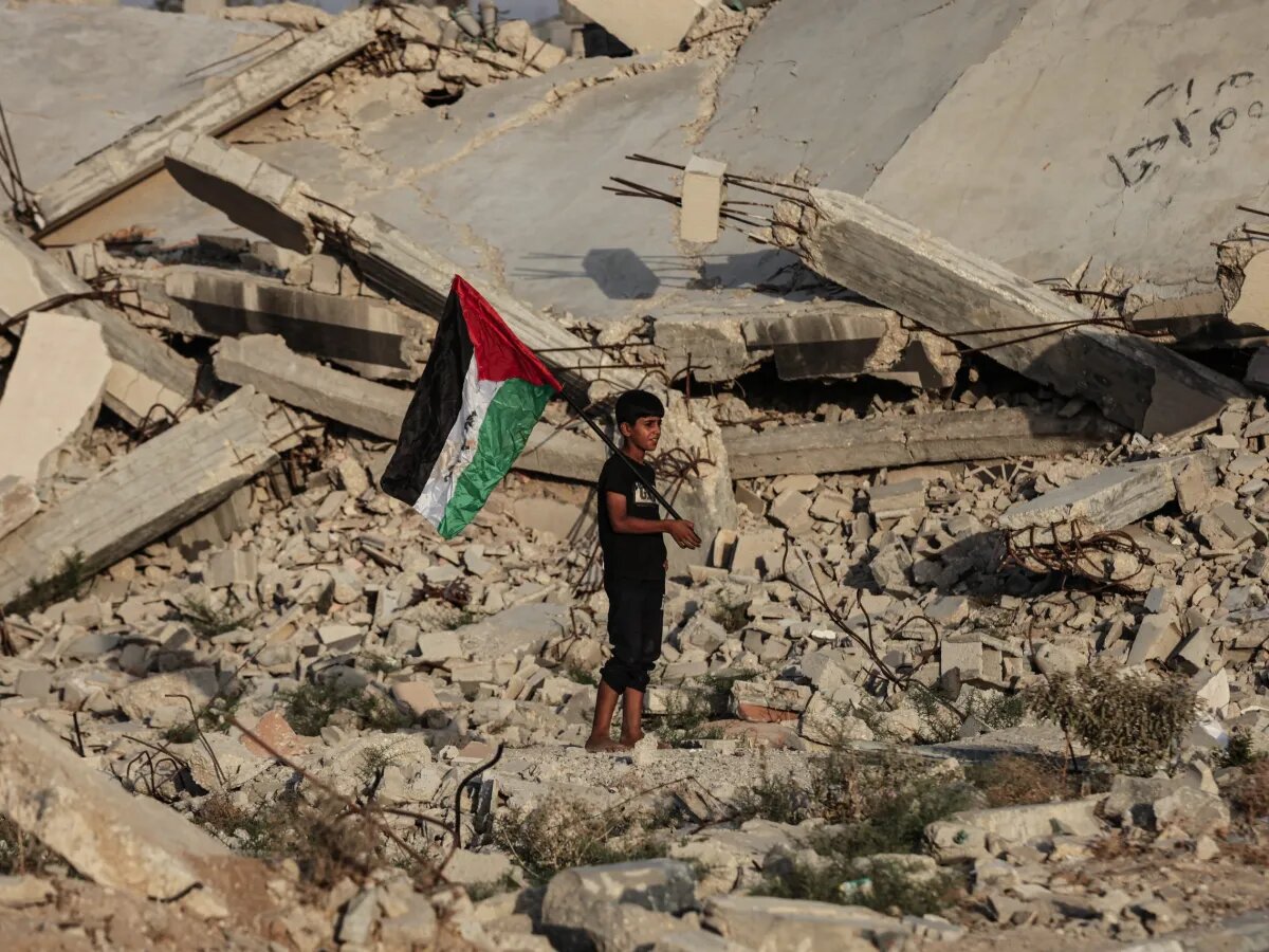 Gaza boy holding a flag