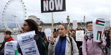 Demonstrators cross the Westminster Bridge as people participate in a silent procession during a vigil for Gaza in London, Britain on 10 February, 2024 (Reuters)