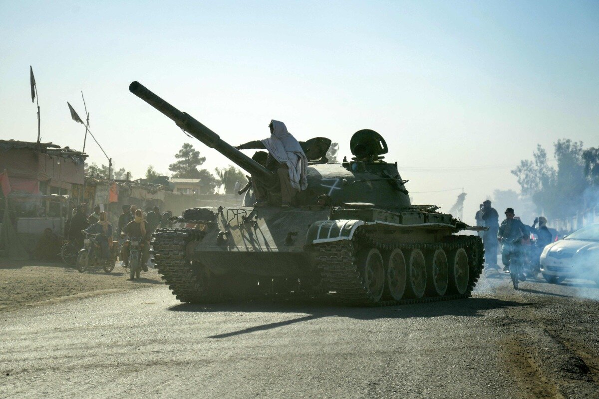 Taliban security personnel on a Soviet-era tank are followed by motorcyclists as they ride towards the border in the Spin Boldak district of Kandahar Province on October 15, 2025. (Photo: Sanaullah SEIAM / AFP)