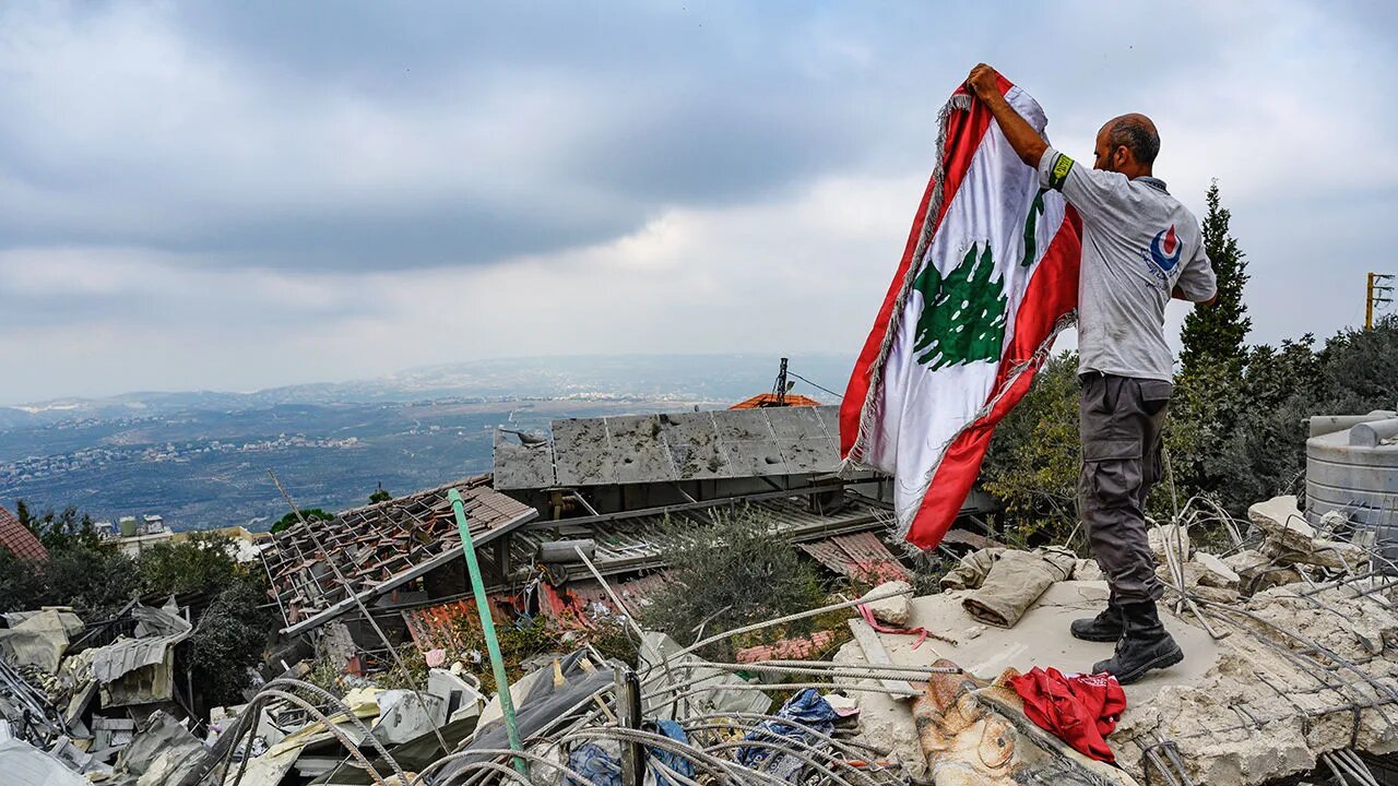 Lebanese flag above rubble