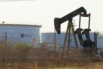 An oil pumpjack and a tank with the corporate logo of PDVSA are seen in an oil facility in Lagunillas, Venezuela, January 2019 (Reuters)