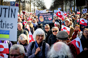 Demonstrators hold Greenland flags as they protest in front of the U.S. embassy, in Copenhagen, March 29, 2025 (AP)