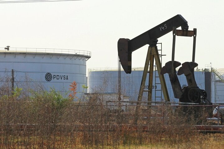 An oil pumpjack and a tank with the corporate logo of PDVSA are seen in an oil facility in Lagunillas, Venezuela, January 2019 (Reuters)