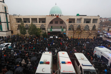 Mourners attend the funeral outside the Imam Ali ibn Abi Talib Mosque in Homs, Syria, December 27, 2025 (AP)