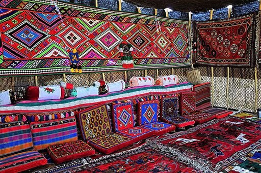 Vivid colors of Qashqai carpets enliven black tents