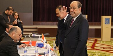 Former Iraqi prime minister Nouri al-Maliki casts his vote at a polling station in Baghdad during Iraq’s parliamentary elections on November 11, 2025.