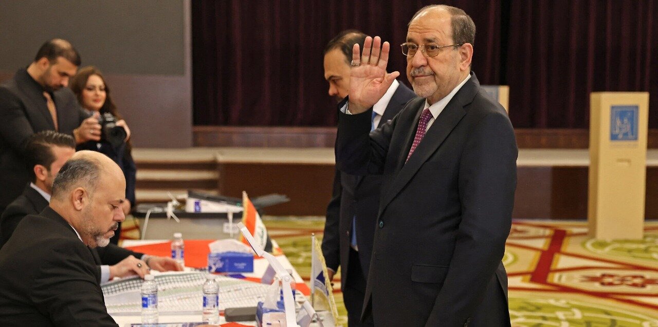Former Iraqi prime minister Nouri al-Maliki casts his vote at a polling station in Baghdad during Iraq’s parliamentary elections on November 11, 2025.