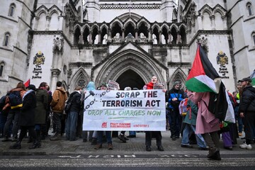 People protest outside the High Court as judges prepare to rule on a legal challenge to the decision to designate Palestine Action as a terrorist organization, London, the UK, February 13, 2026 (Reuters)
