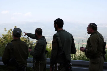 Israeli soldiers stand near the Israel-Lebanon border [File: Florion Goga/Reuters]