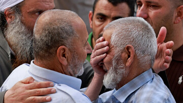 Family members of one of the four Palestinians killed on Friday weeps outside a hospital in Nablus, in the occupied West Bank [AFP]