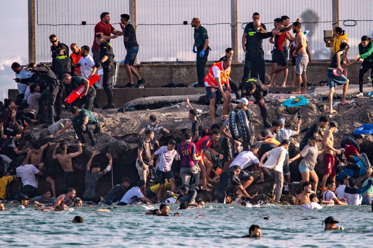 Migrants try to cross from Morocco into the Spanish enclave of Ceuta, July 30, 2026. (AP Photo/Antonio Sempere)