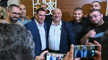 The head of the Arab-majority party Ra'am, Mansour Abbas (right), appears with new party member Yoav Segalovitz (left) in Nazareth on Aug. 31, 2026. (Michael Giladi/FLASH90)